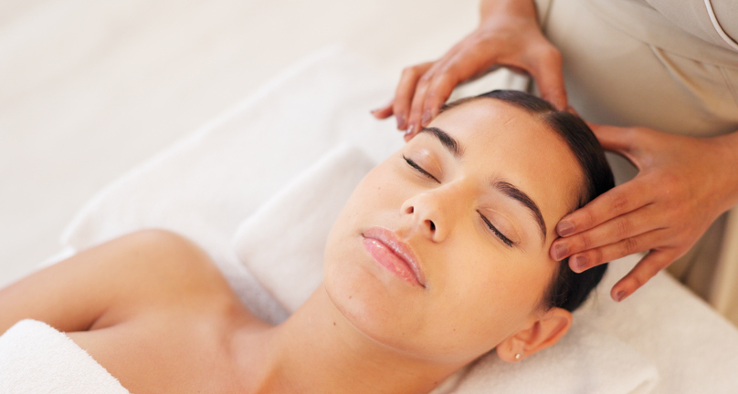 spa, head massage and calm woman enjoying a relaxing treatment in a wellness, health and beauty center. relax, peace and therapist doing relaxation therapy for a girl at a luxury natural salon.